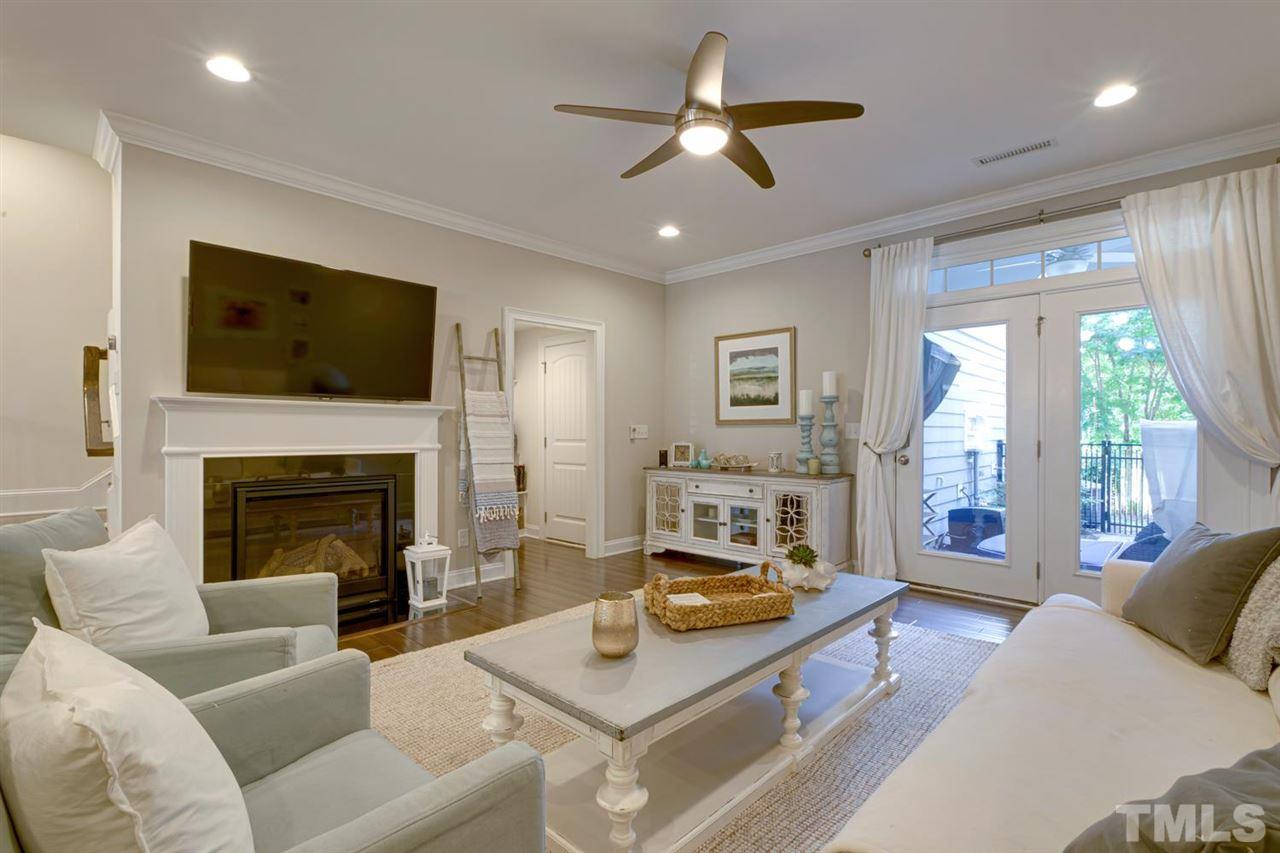 708 Fallon Grove Way Raleigh, NC 27608 - Photo 14 of 30 a living room with furniture a flat screen tv and a fireplace