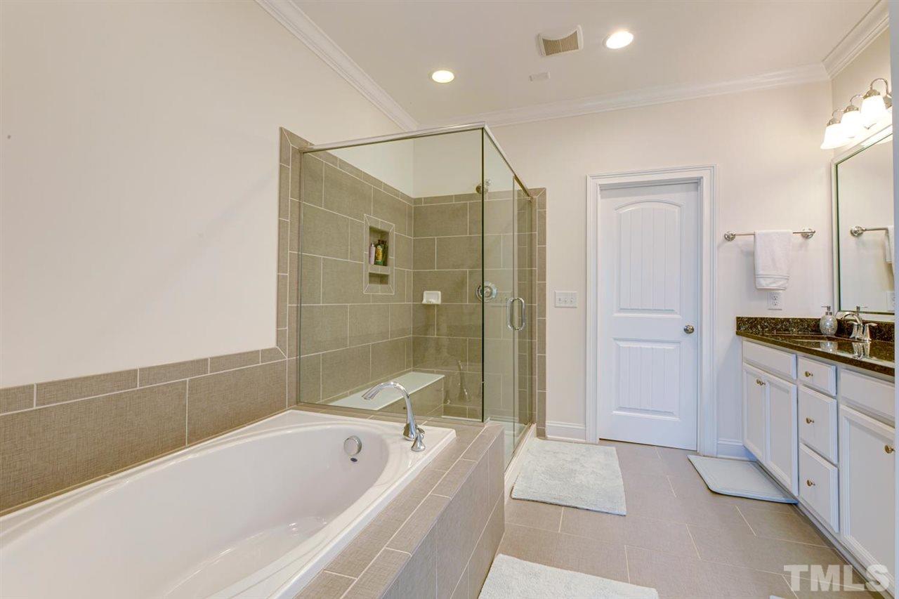 708 Fallon Grove Way Raleigh, NC 27608 - Photo 20 of 30 a spacious bathroom with a tub shower and sink