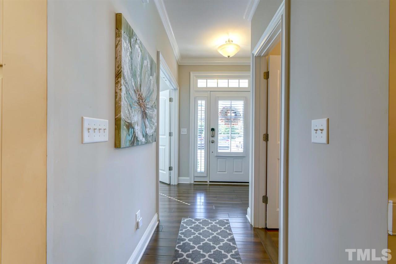 708 Fallon Grove Way Raleigh, NC 27608 - Photo 3 of 30 a view of a hallway with wooden floor and a bathroom