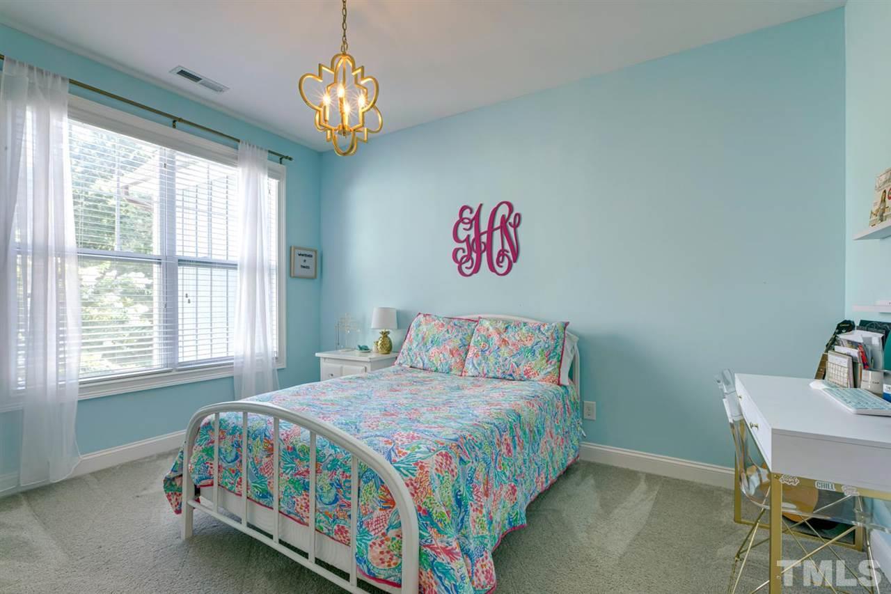 708 Fallon Grove Way Raleigh, NC 27608 - Photo 22 of 30 a bedroom with a bed and a table in it