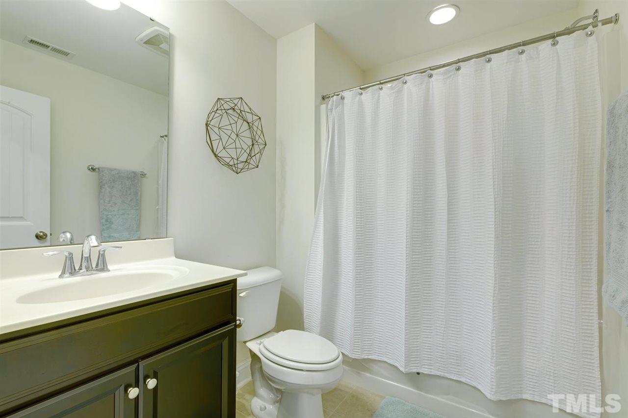 708 Fallon Grove Way Raleigh, NC 27608 - Photo 26 of 30 a bathroom with a toilet a sink and a mirror