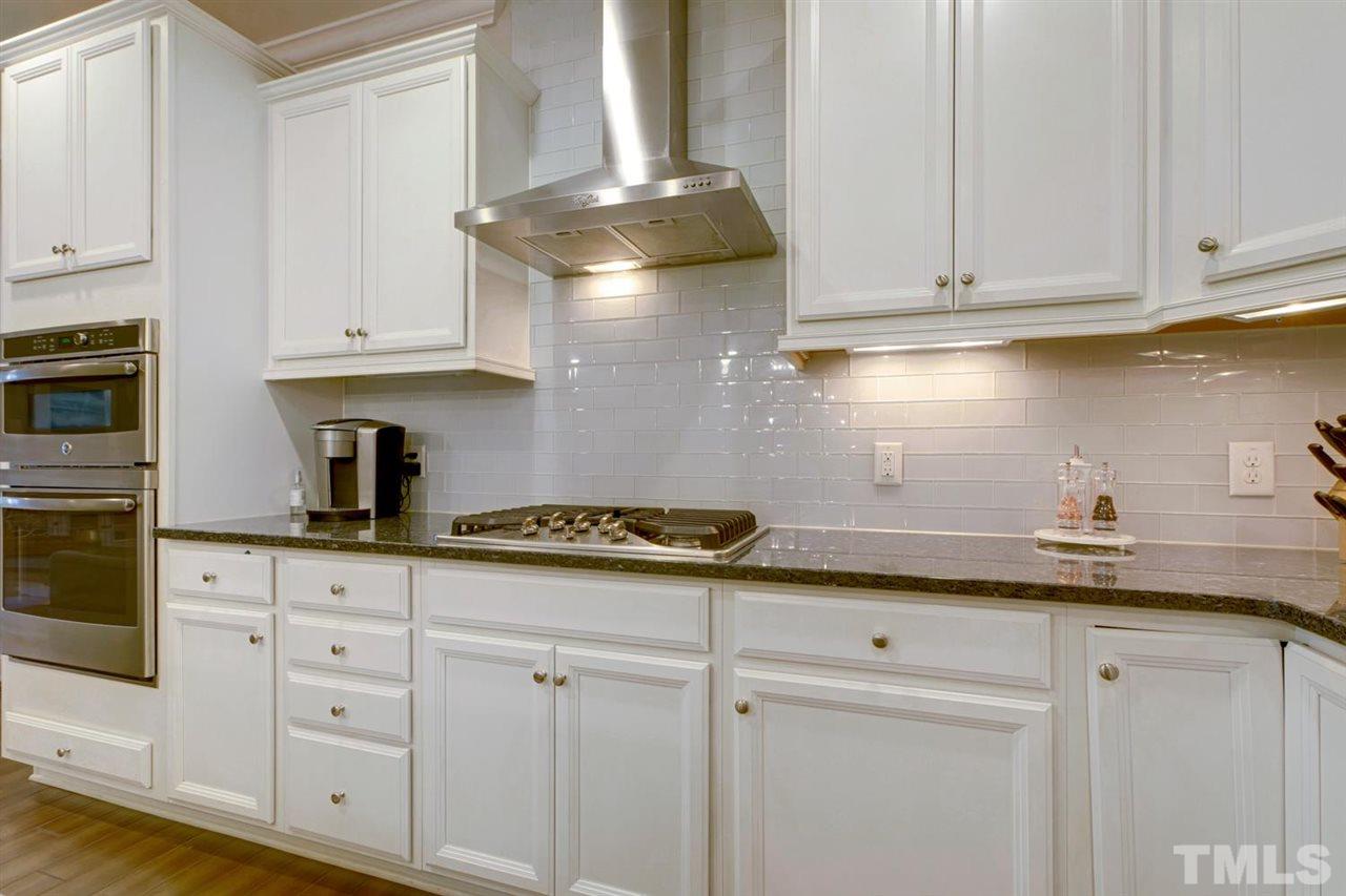 708 Fallon Grove Way Raleigh, NC 27608 - Photo 9 of 30 a kitchen with granite countertop white cabinets and a stainless steel appliances