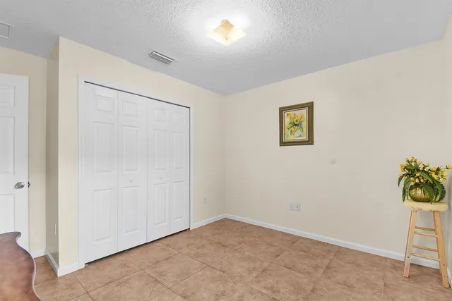 an empty room with a painting on the wall