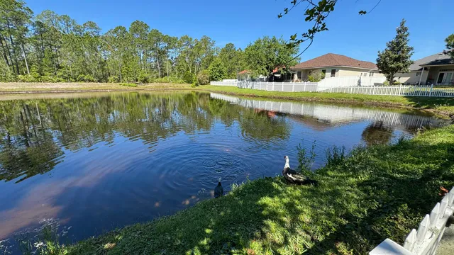 a view of a lake with a house in the background