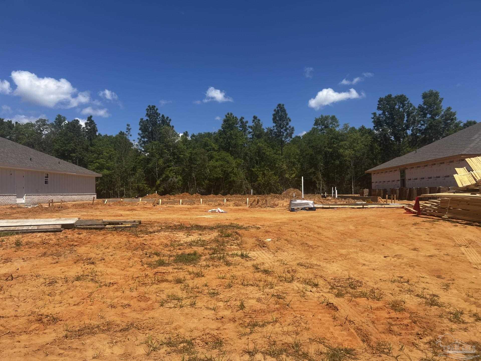 5280 Muscadine Way Milton, FL 32570 - Photo 2 of 3 a swimming pool with outdoor seating and yard