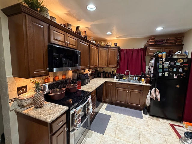 737 Wasatch Street Midvale, UT 84047 - Photo 4 of 29 Kitchen featuring wood cabinetry, granite-style countertops, and tile flooring