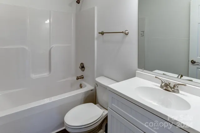 a bathroom with a sink a toilet and a bathtub