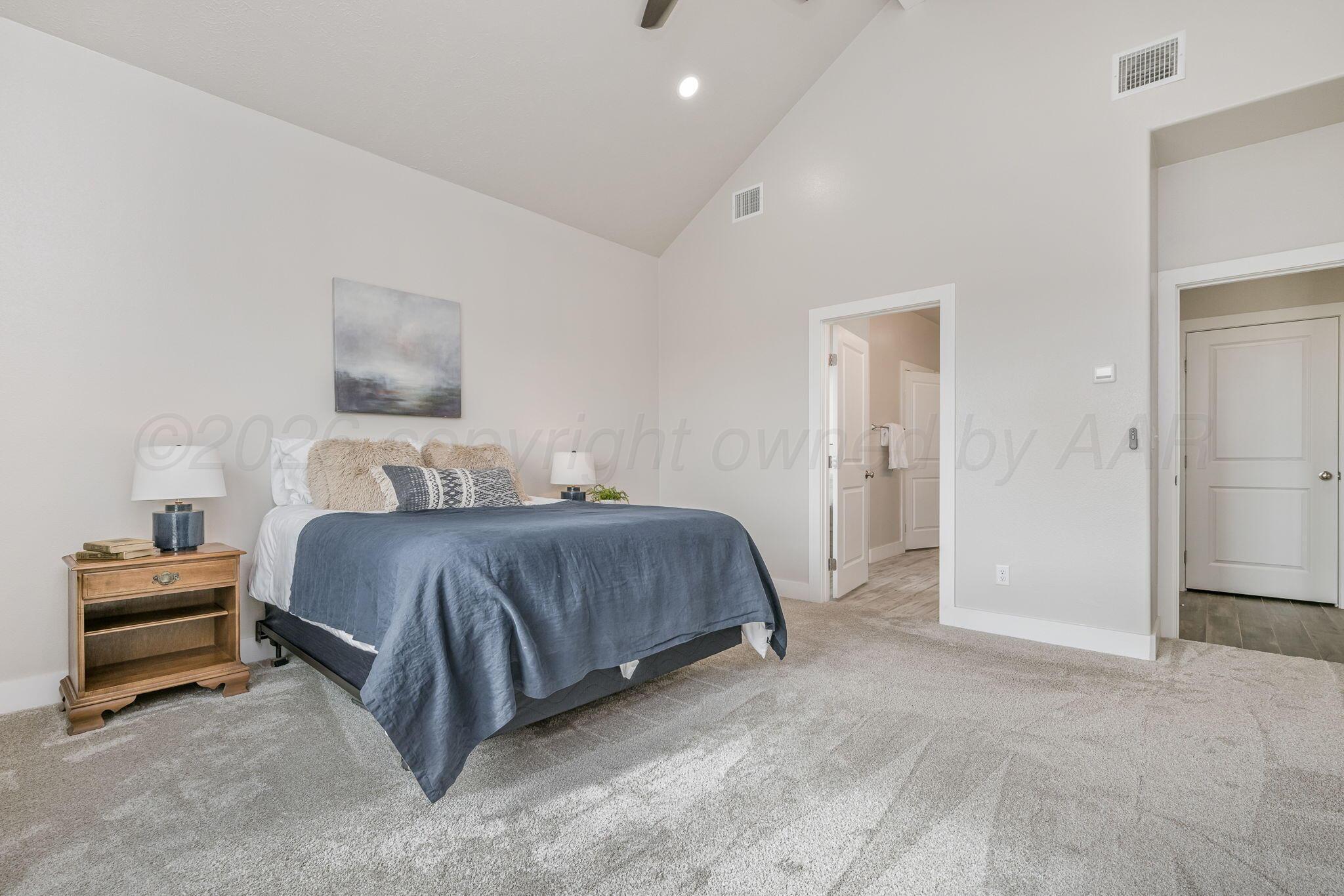 26150 Newton Road Canyon, TX 79015 - Photo 16 of 43 a bedroom with a bed and a painting on the wall