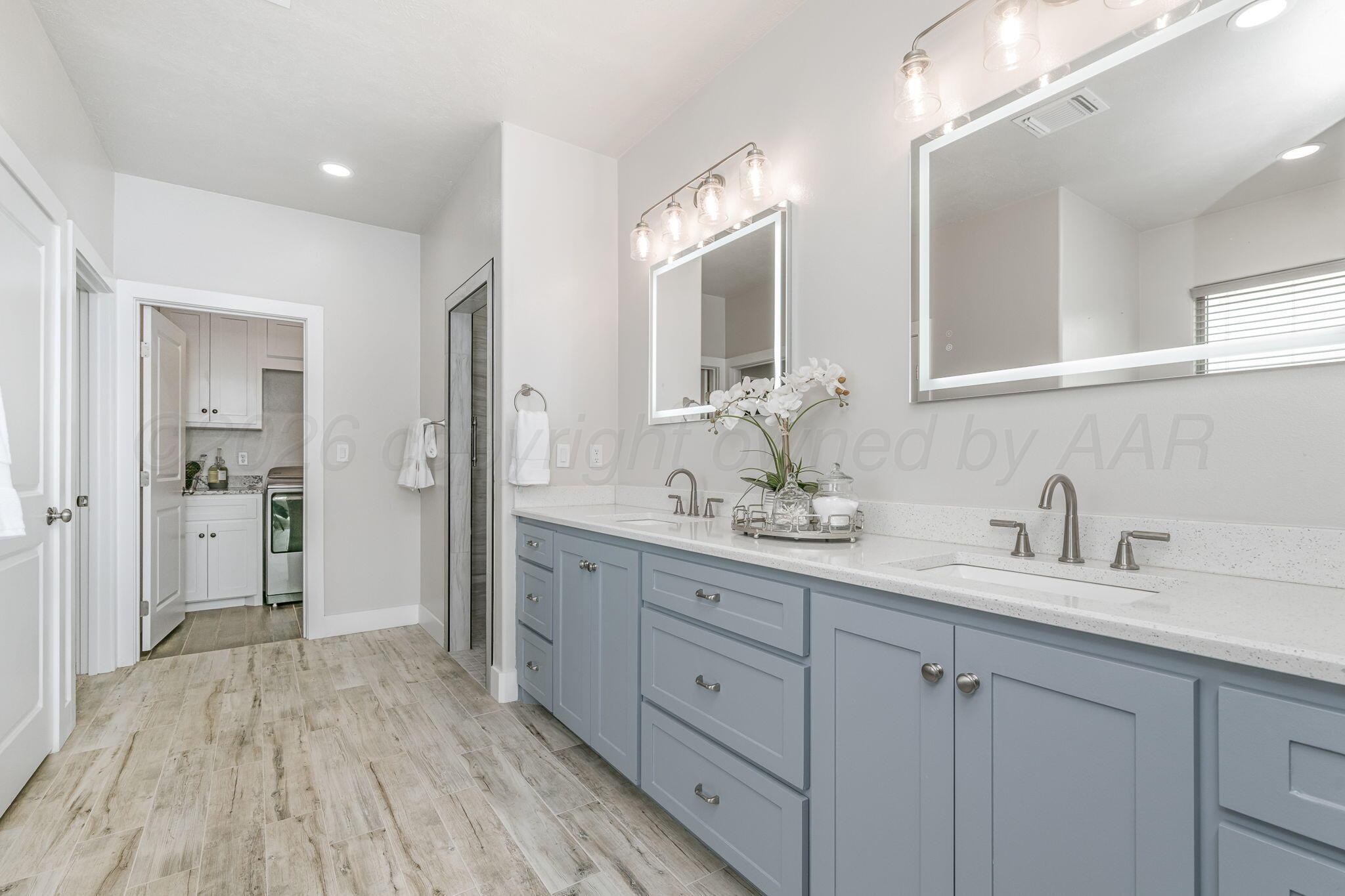 26150 Newton Road Canyon, TX 79015 - Photo 17 of 43 a spacious bathroom with a granite countertop sink mirror and