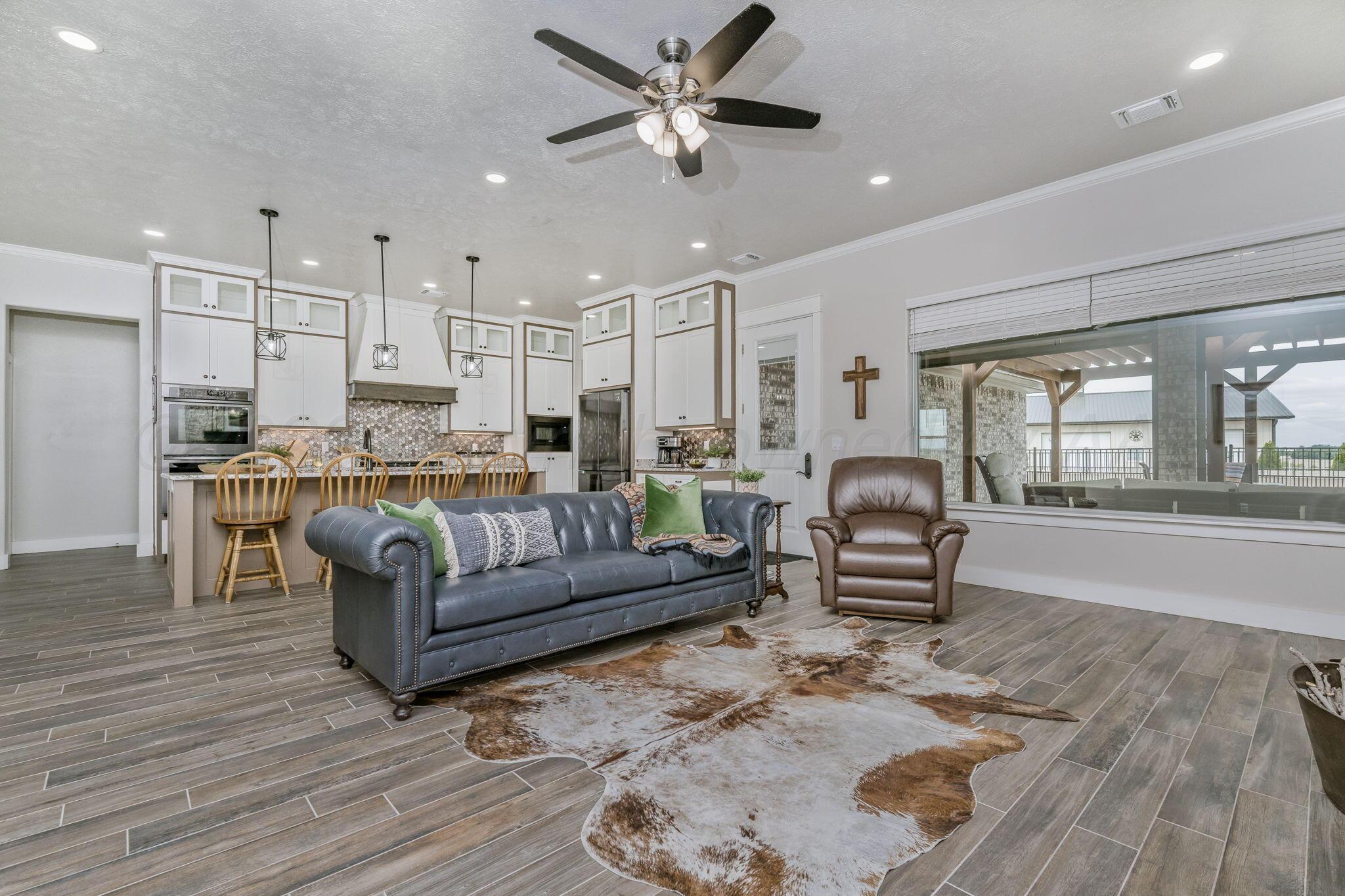 26150 Newton Road Canyon, TX 79015 - Photo 10 of 43 a living room with furniture and a wooden floor