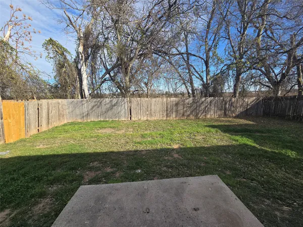 a view of a backyard with large trees
