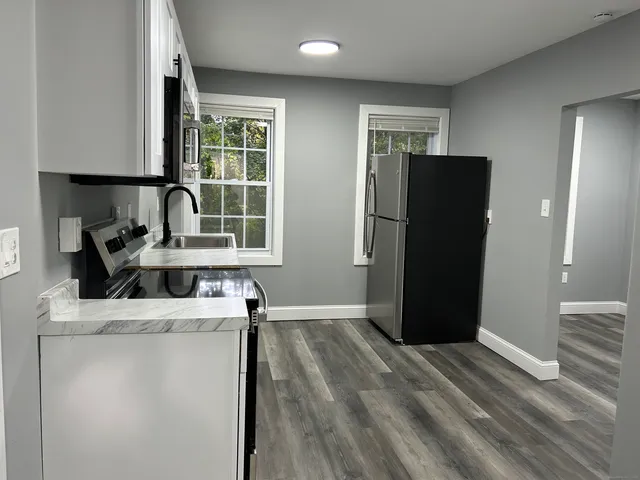 a kitchen with a refrigerator and a sink