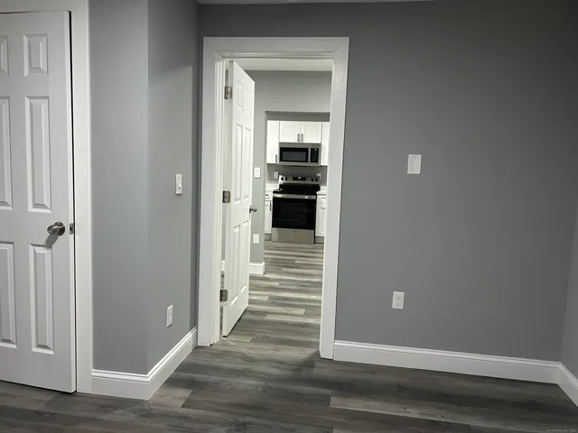 a view of a hallway view with wooden floor and staircase