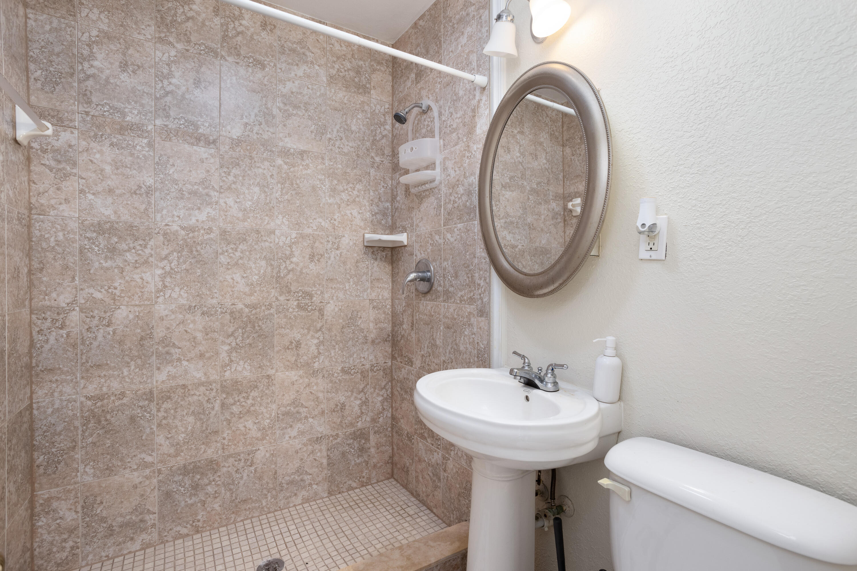 319 West Rutgers Street Melbourne, FL 32901 - Photo 13 of 19 a bathroom with a sink a mirror and toilet