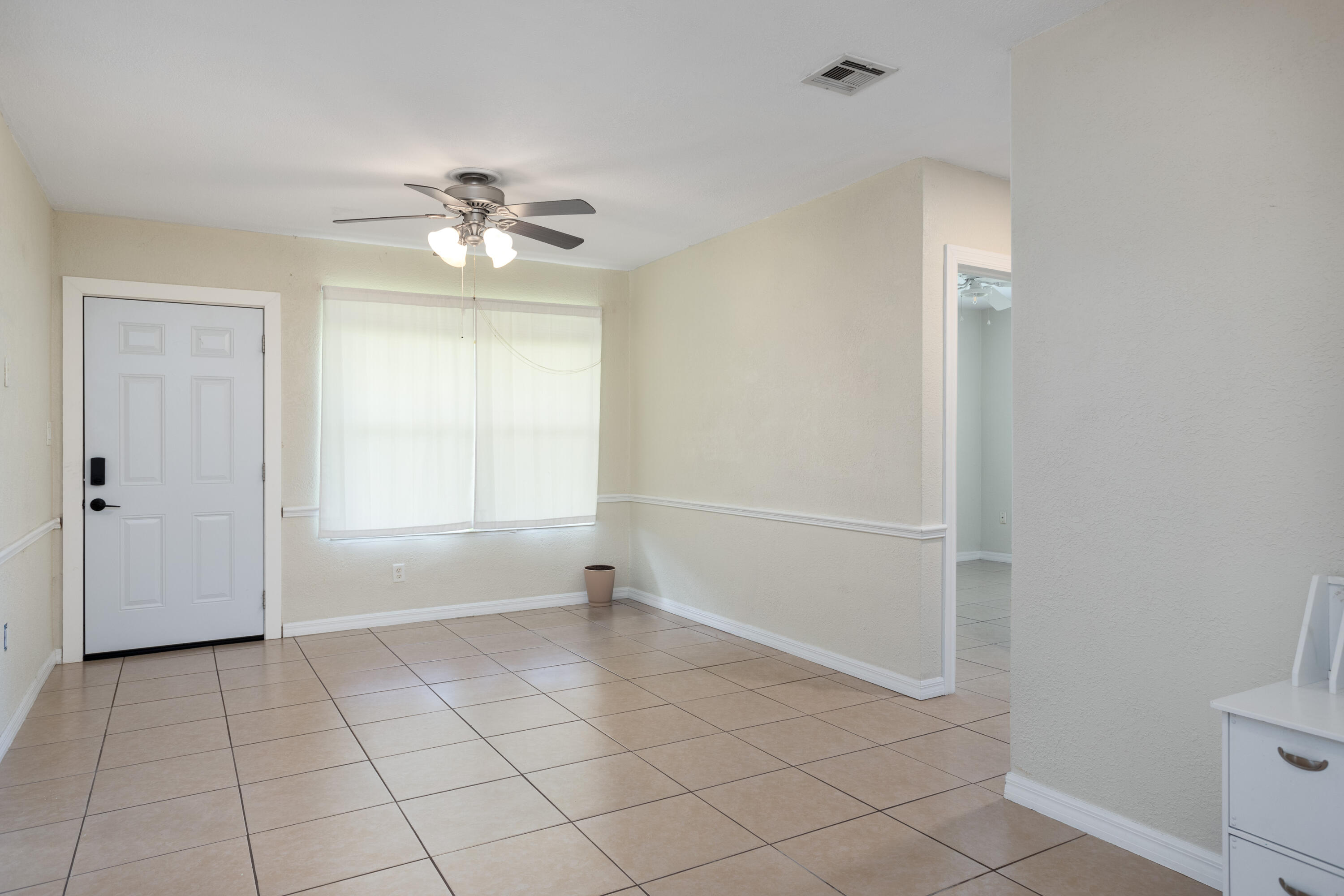 319 West Rutgers Street Melbourne, FL 32901 - Photo 2 of 19 a view of an empty room with a window