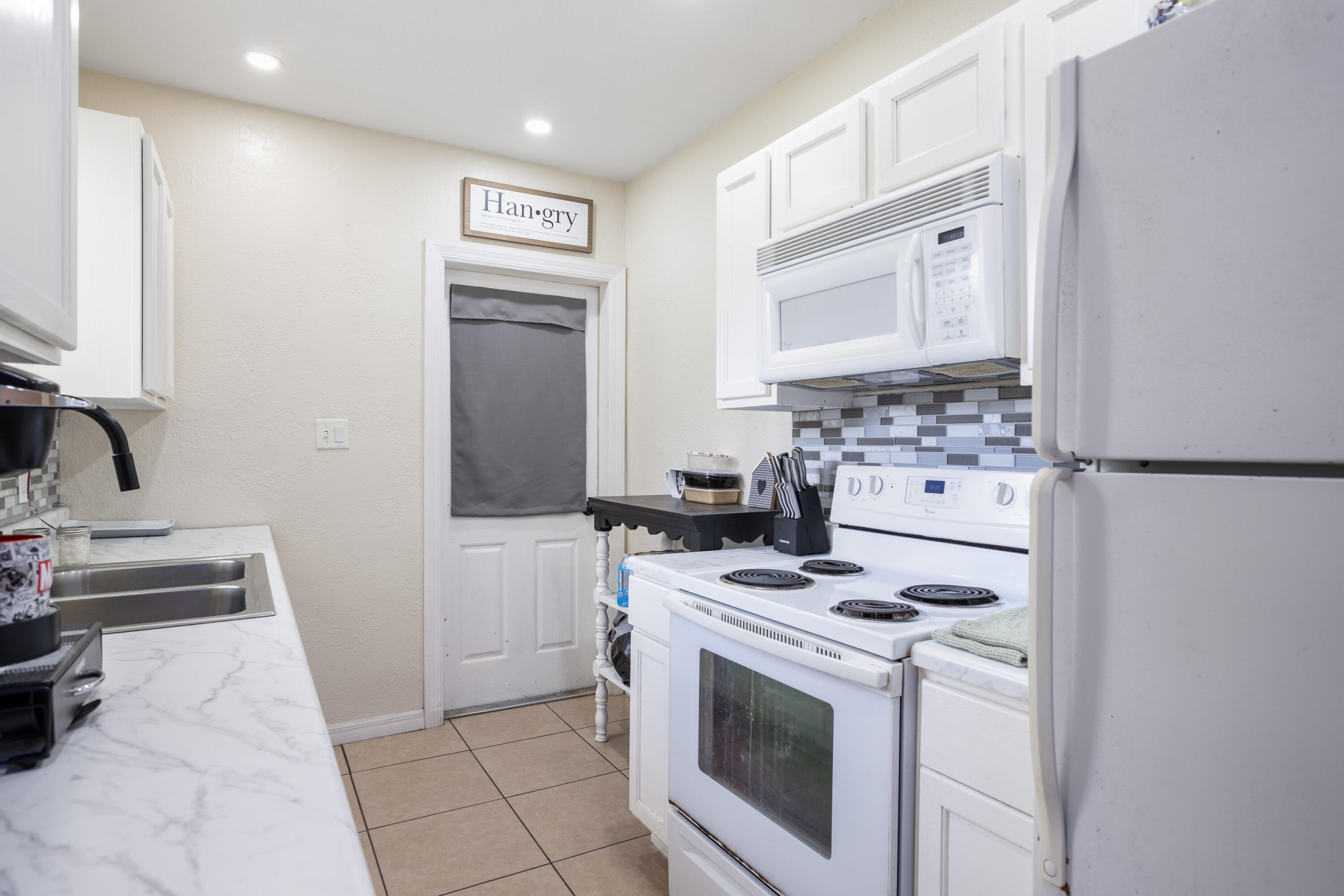 319 West Rutgers Street Melbourne, FL 32901 - Photo 6 of 19 a kitchen with a stove and a sink