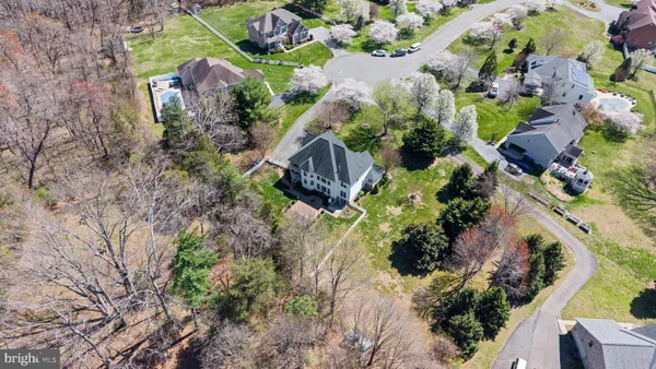a kitchen with stainless steel appliances granite countertop a sink dishwasher a refrigerator and a stove with wooden floor