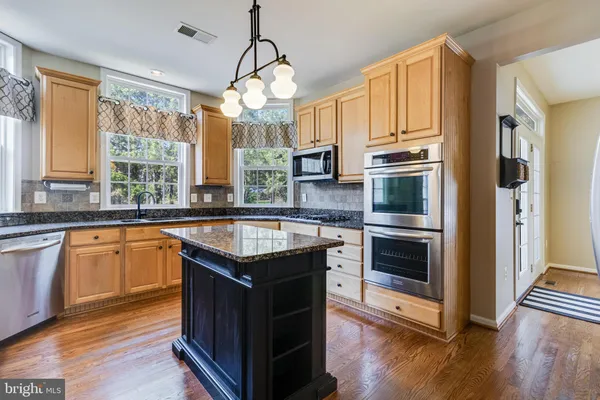 a spacious bedroom with a bed and a chandelier