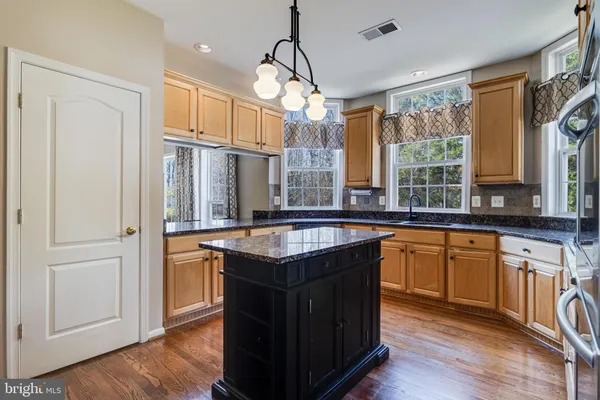 a large kitchen with a sink and cabinets