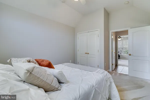 a view of a big room with a ceiling fan and carpet