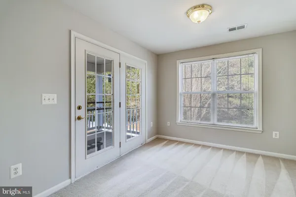 an empty room with wooden floor and window