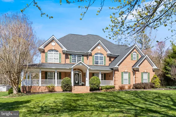 a view of a house with a yard porch and sitting area