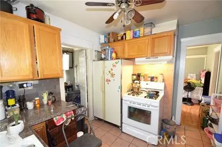 a kitchen with stainless steel appliances kitchen island granite countertop a refrigerator and a stove