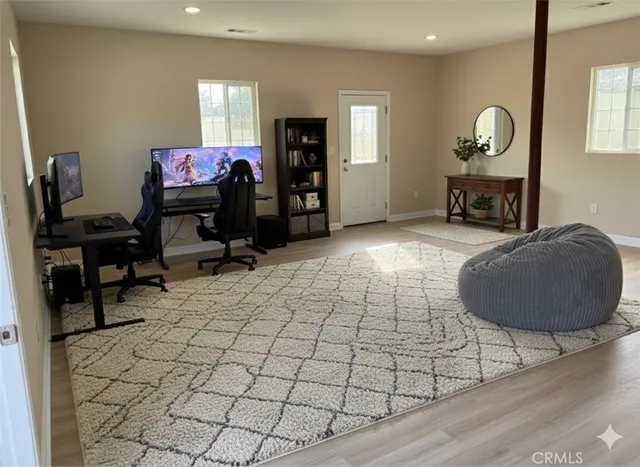 a room with a table chairs and a lamp