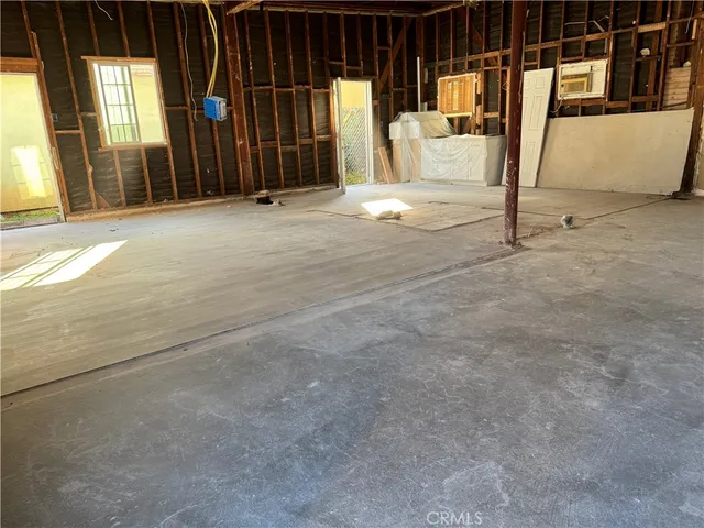 a living room with stainless steel appliances kitchen island granite countertop furniture and a living room