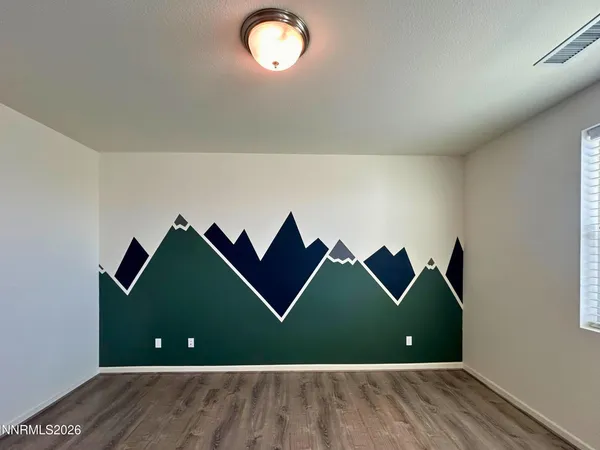 an empty room with windows and ceiling fan