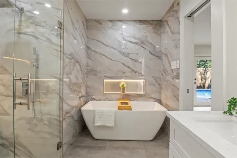 a bathroom with a bathtub and shower