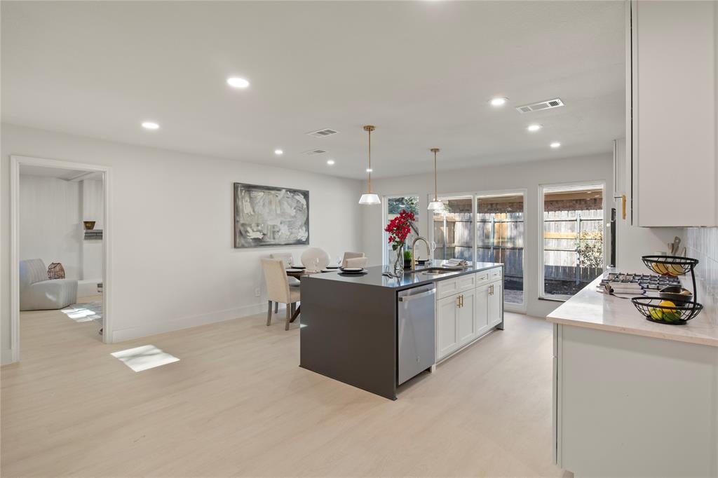 10427 Carry Back Place Dallas, TX 75229 - Photo 19 of 40 a kitchen with counter top space and stainless steel appliances