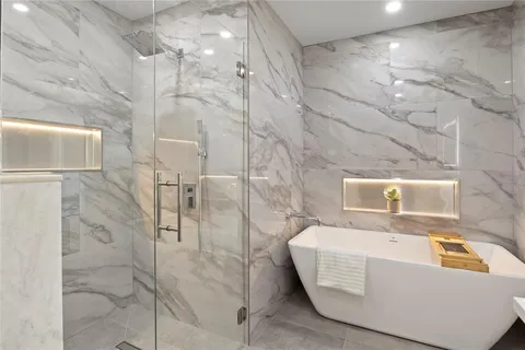 a bathroom with a bathtub and shower