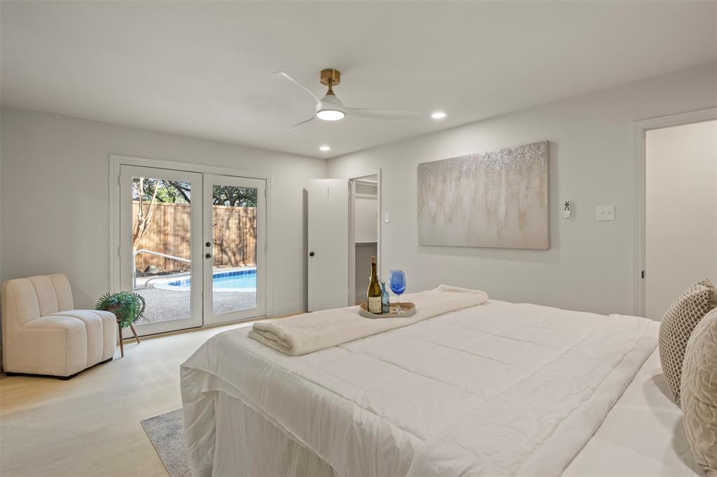 10427 Carry Back Place Dallas, TX 75229 - Photo 23 of 40 a spacious bedroom with a bed and glass window