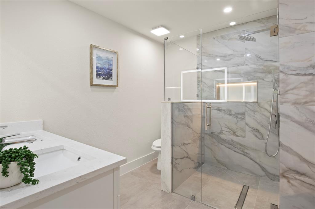 10427 Carry Back Place Dallas, TX 75229 - Photo 25 of 40 a bathroom with a toilet sink and shower