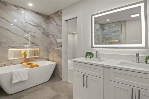 a bathroom with a sink toilet and a mirror