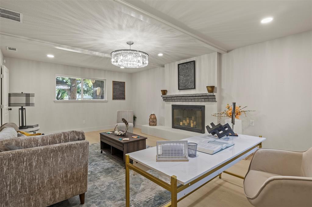 10427 Carry Back Place Dallas, TX 75229 - Photo 28 of 40 a living room with furniture and a fireplace