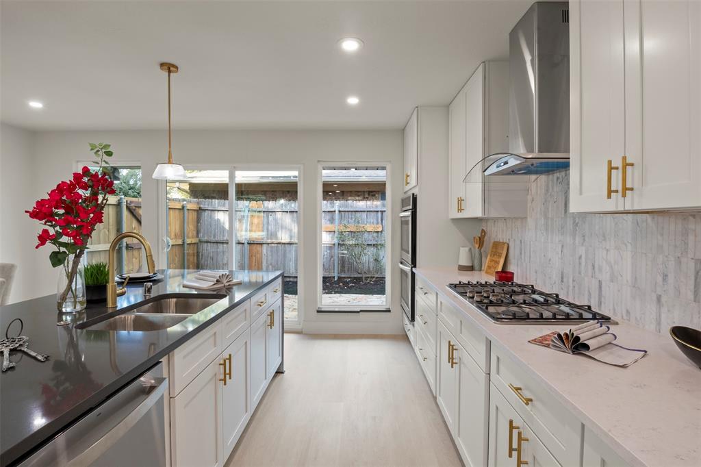 10427 Carry Back Place Dallas, TX 75229 - Photo 3 of 40 Chef's Kitchen featuring 8 ft long quartz island and stainless steel appliances