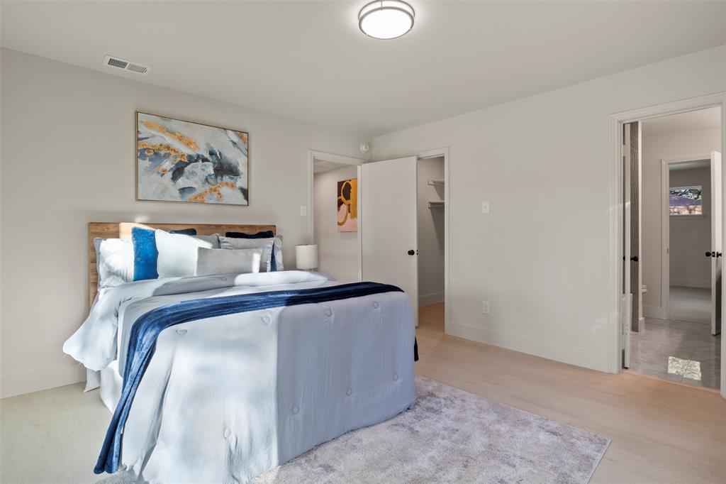 10427 Carry Back Place Dallas, TX 75229 - Photo 31 of 40 a bed room with a bed and painting on the wall