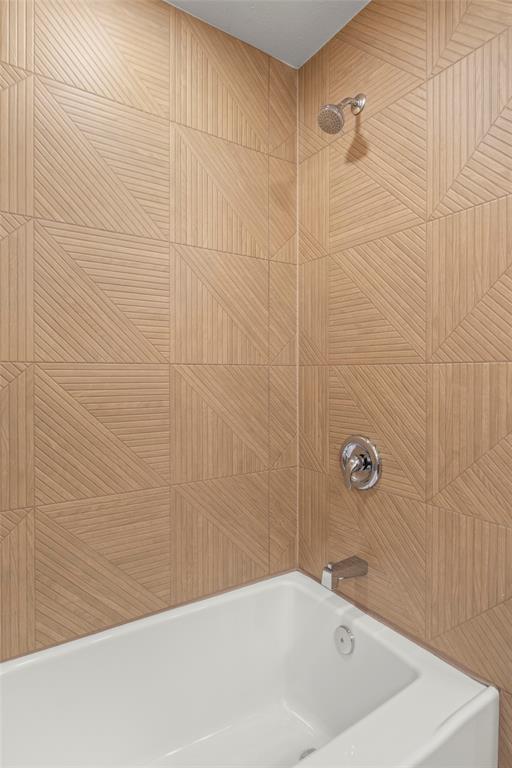 10427 Carry Back Place Dallas, TX 75229 - Photo 33 of 40 a bathroom with a bathtub