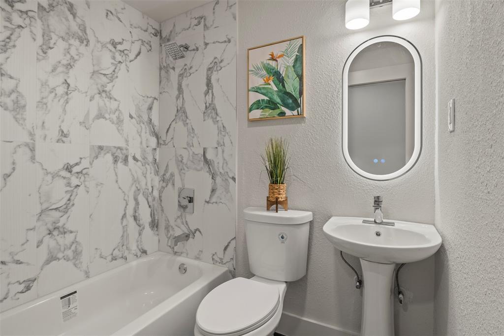 10427 Carry Back Place Dallas, TX 75229 - Photo 35 of 40 a bathroom with a sink toilet and a mirror