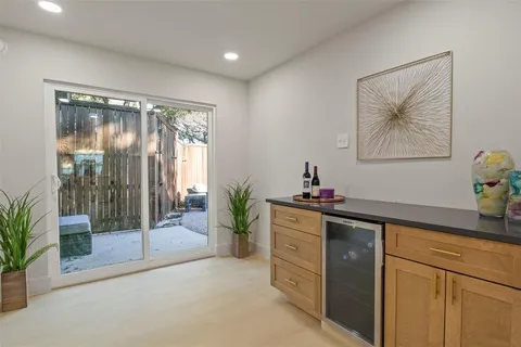 a backyard of a house with fountain table and chairs