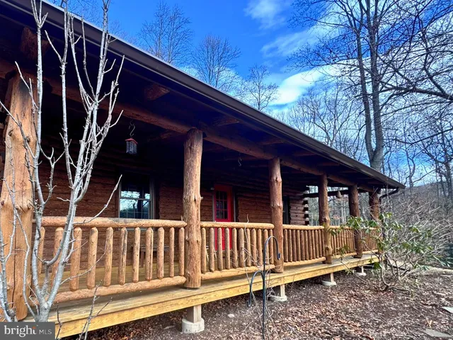 a view of a house with a small deck and furniture