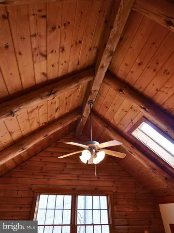 a room with wooden floors and lots of windows