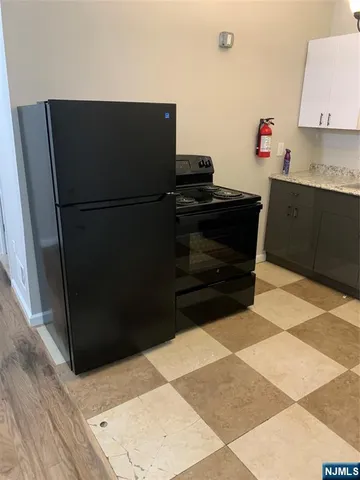 a kitchen with a refrigerator and a stove