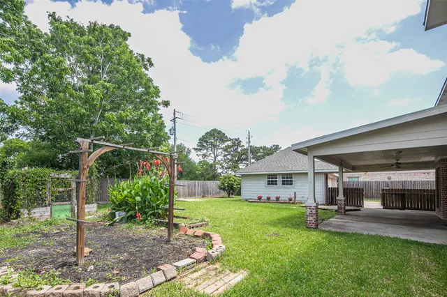 a view of a house with backyard and porch