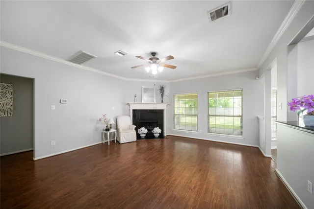 a view of a room with furniture a fireplace and wooden floor