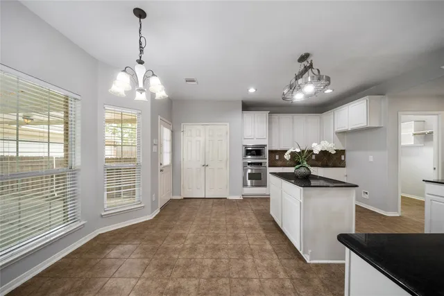 a view of a kitchen with sink stainless steel appliances and cabinets