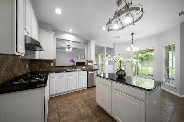 a kitchen with a counter space cabinets and appliances