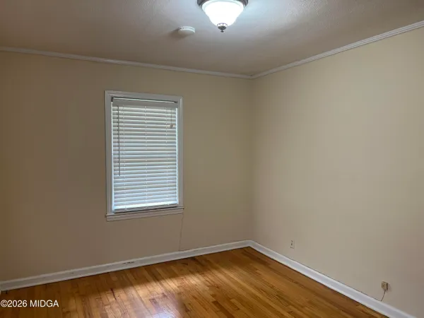 a view of a room with wooden floor and windows